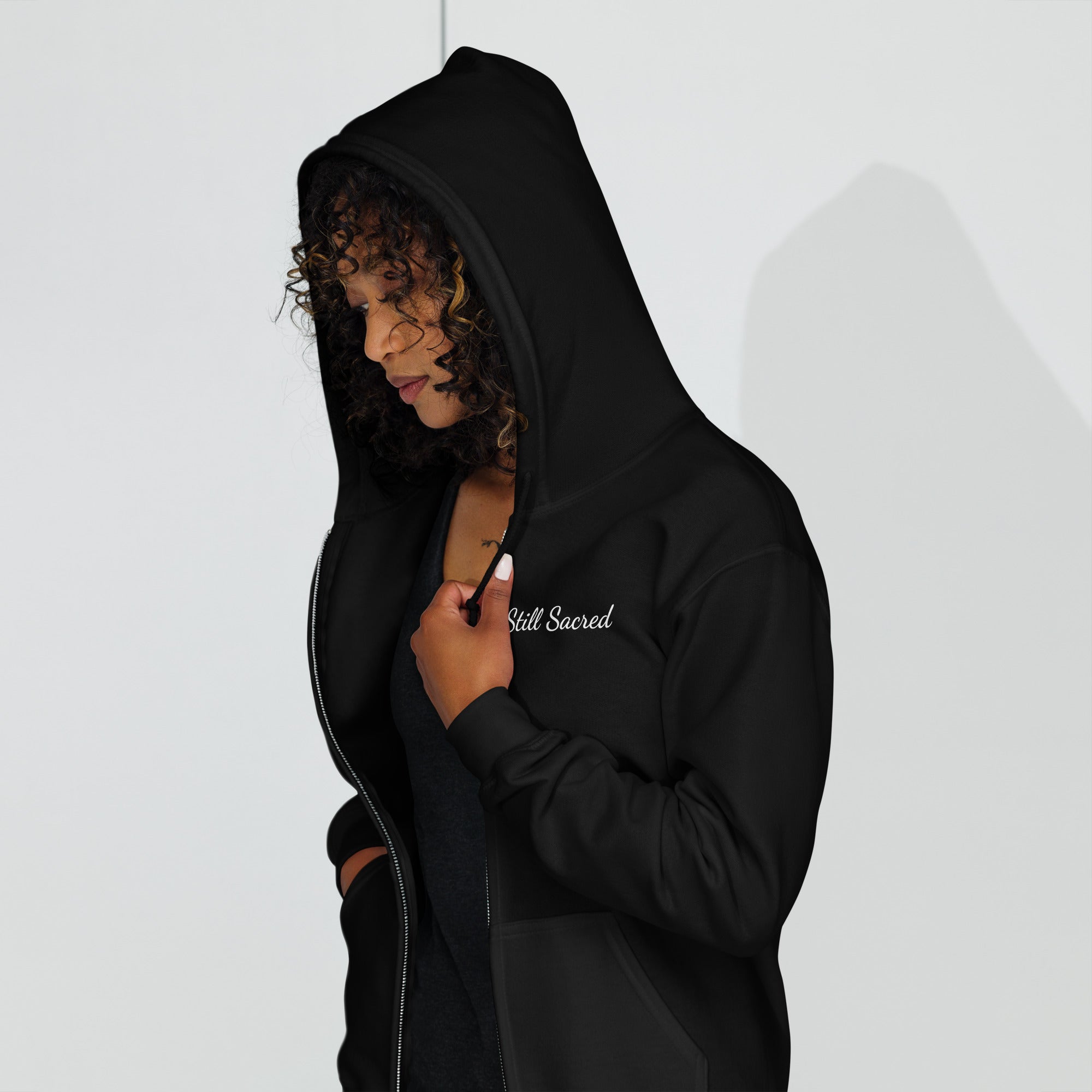 Black Still Sacred zip-up hoodie – Shade printed on right arm, streetwear design, left side view