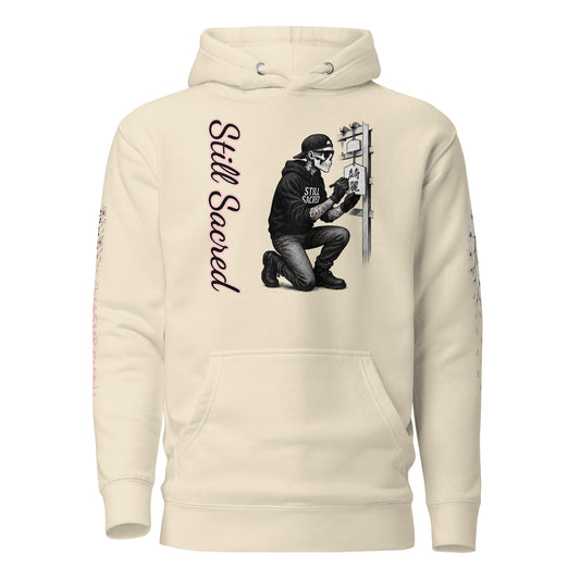 Bone-colored hoodie with Skelly kneeling at an Ema board on the front, a sakura tree shedding petals on the back, left sleeve with falling blossoms, and right sleeve featuring the kanji 「忘れない」 with cherry blossoms and “WASURENAI” vertically beneath.